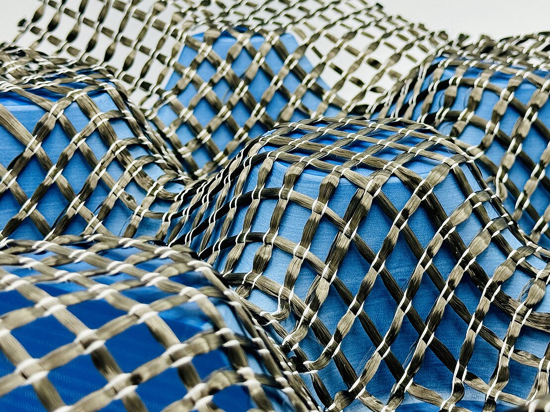 Close-up of a tessellated carbon fiber textile reinforcement in a preliminary study